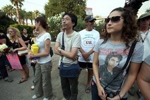 Michael Jackson fans stand outside the Jackson family residence in the Encino